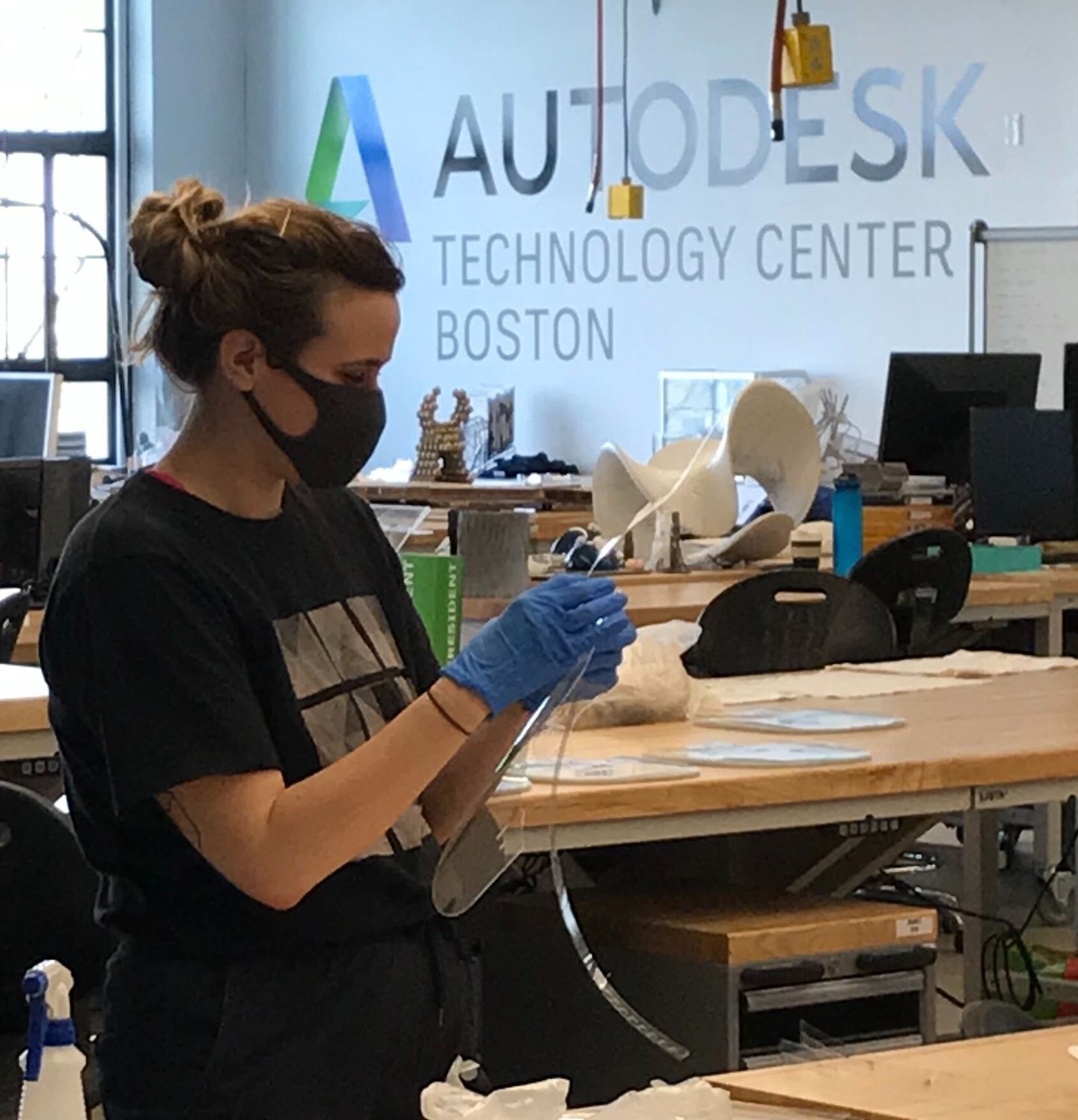 woman constructs a face shield